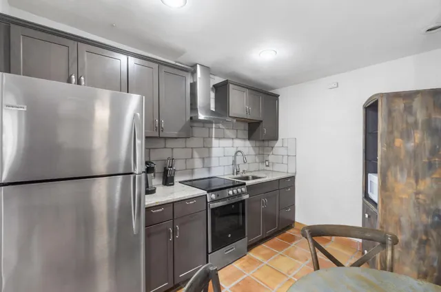 an aerial view of a house with a swimming pool and outdoor space