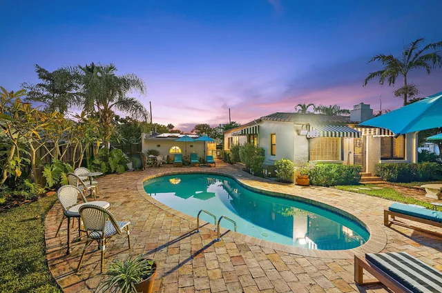 a house with swimming pool in front of it