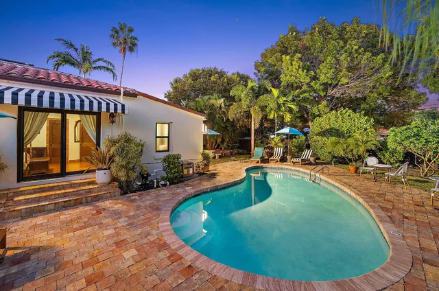 a view of a swimming pool with an outdoor seating