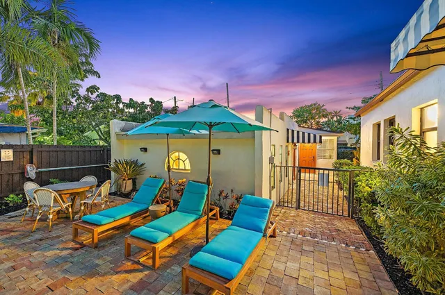 a view of a patio with a table and chairs