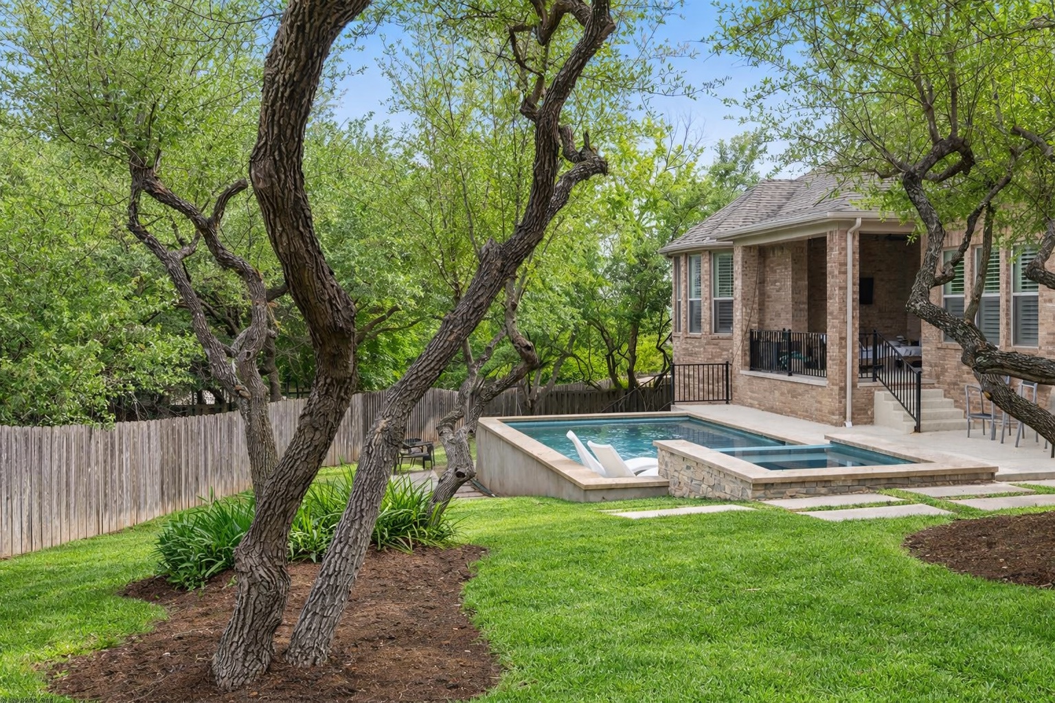 8801 Wild Rice Cove Austin, TX 78738 - Photo 37 of 40 a view of a house with backyard and a tree