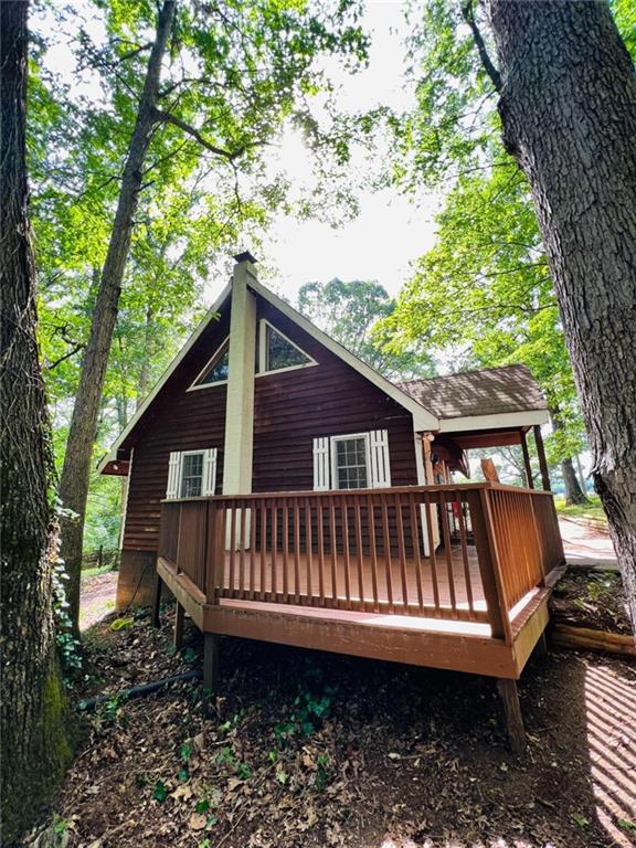 a view of a backyard with a small deck and wooden floor