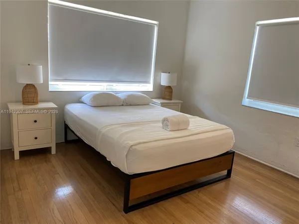 a bedroom with a bed and a night stand