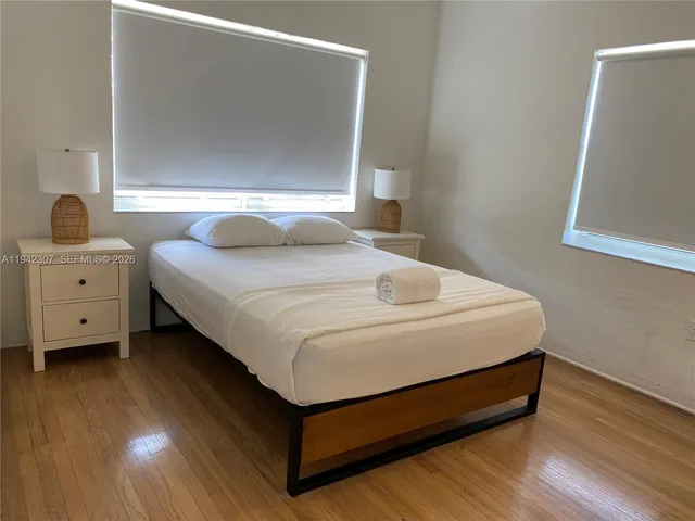 a bedroom with a bed and a night stand