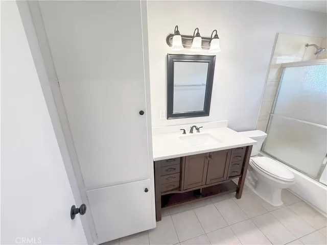 a bathroom with a sink vanity and toilet