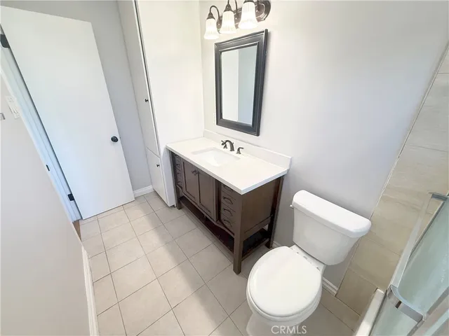 a bathroom with a toilet a sink and a mirror