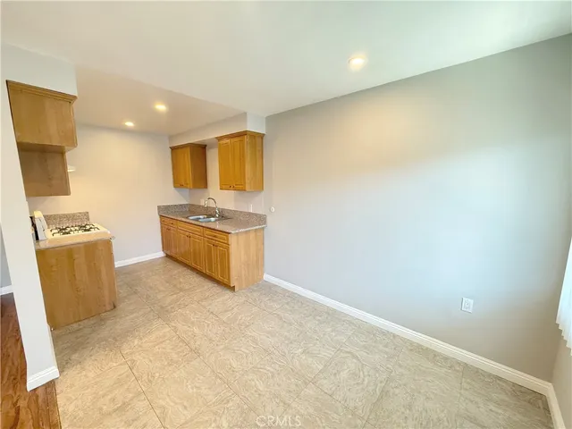 a kitchen with granite countertop a sink and a stove top oven