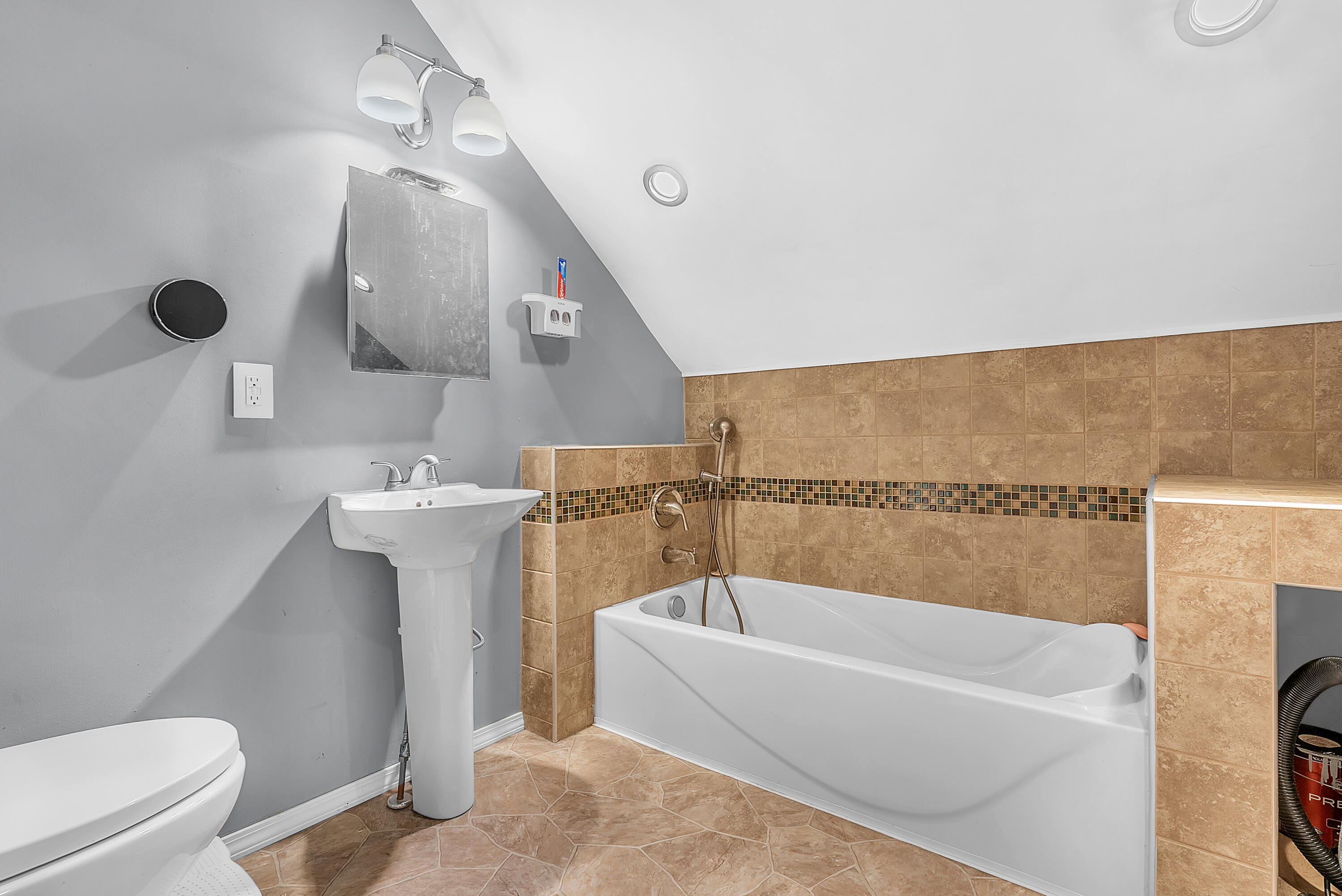 719 Capitol Road Valparaiso, IN 46385 - Photo 11 of 37 a bathroom with a bathtub a toilet a sink and mirror