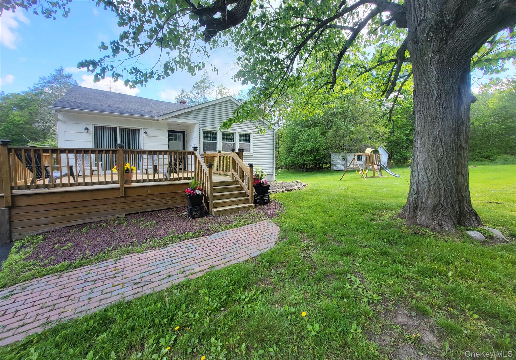 286 Dingle Daisy Road Monticello, NY 12701 - Photo 5 of 35 a view of a house with backyard and a patio