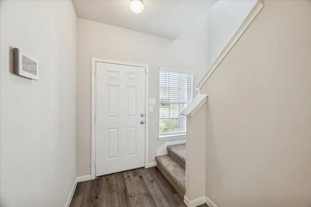 a view of wooden floor and closet in a room