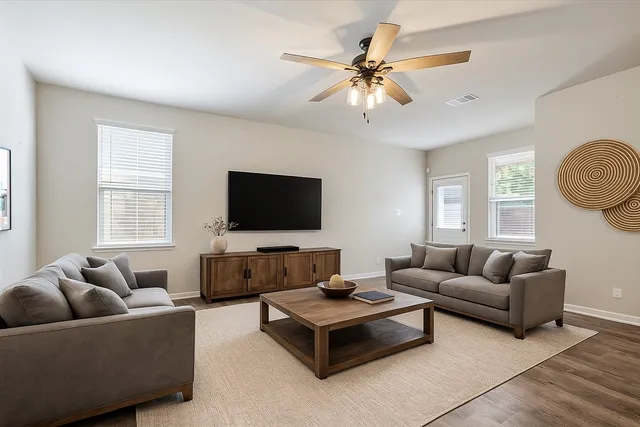 a living room with furniture and a flat screen tv