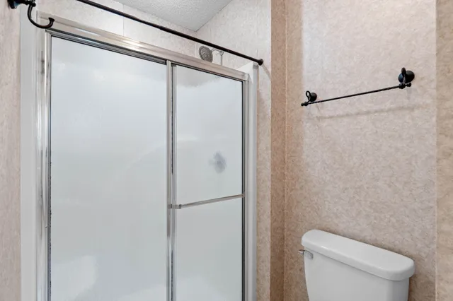 a bathroom with a toilet and a shower