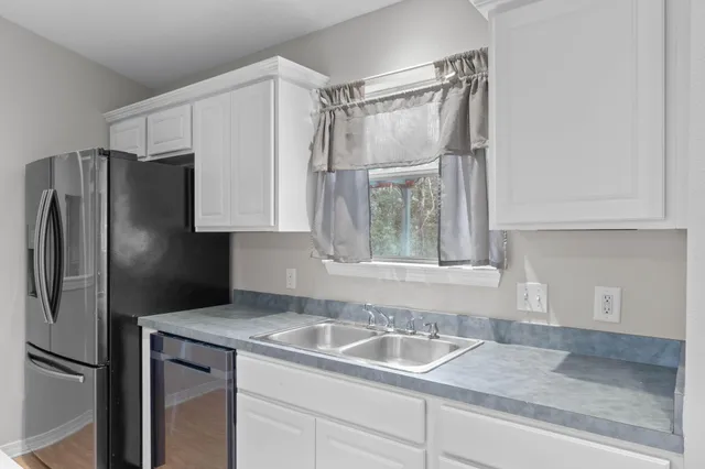 a kitchen with a refrigerator and a sink