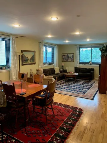 a kitchen with kitchen island a stove a sink a refrigerator and chairs