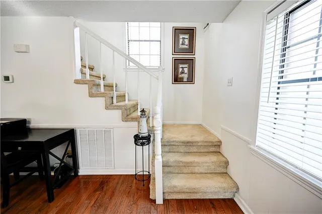 a view of entryway and hall with wooden floor