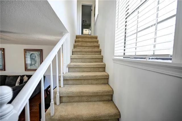 a view of staircase with wooden floor and a window