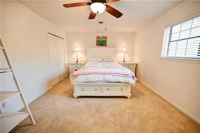 a spacious bedroom with a bed and a window