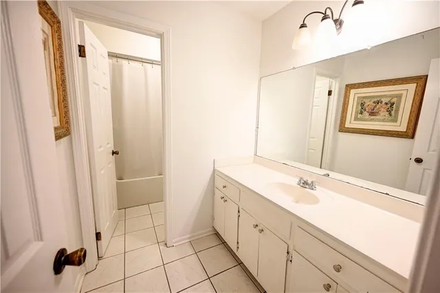 a spacious bathroom with a shower sink and mirror