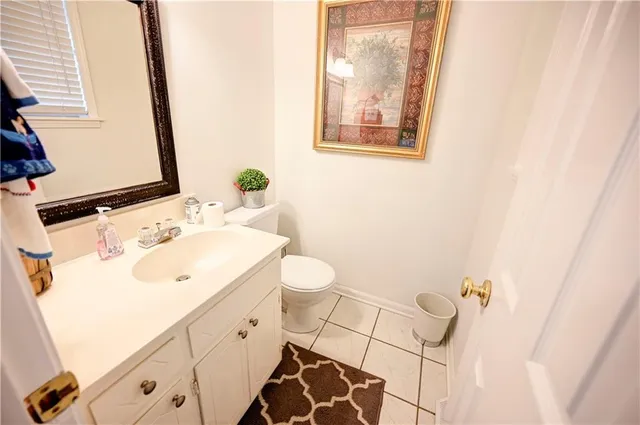 a bathroom with a sink and mirror with toilet