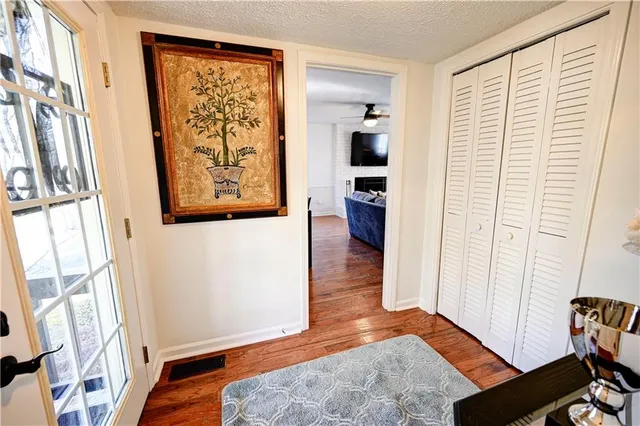 a view of a bedroom with wooden floor and furniture