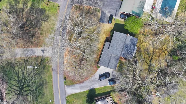 a aerial view of a house with a yard and plants