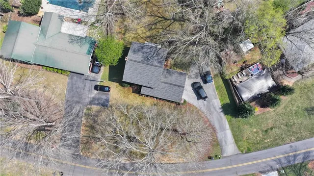 an aerial view of a house with yard