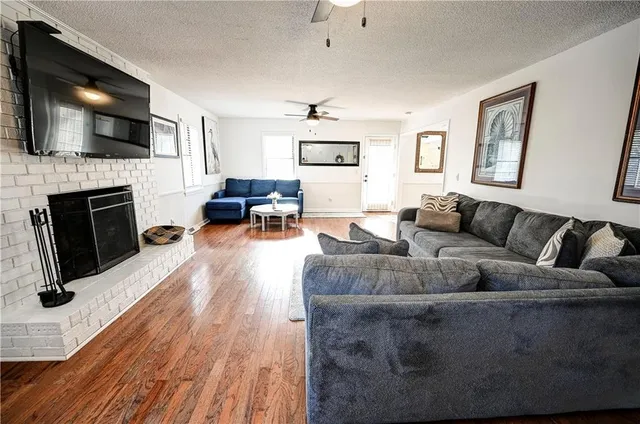 a living room with fireplace furniture and a flat screen tv