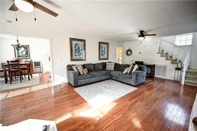 a living room with furniture and wooden floor