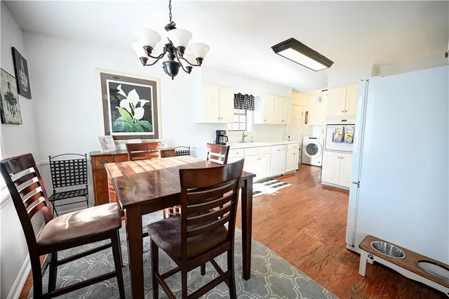 a view of a dining room with furniture and a chandelier