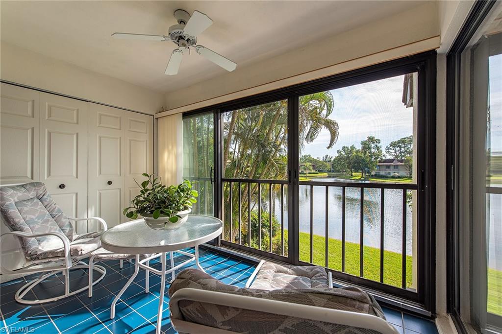 1672 Spoonbill Lane, Unit 1672 Naples, FL 34105 - Photo 12 of 12 a living room with furniture and a floor to ceiling window
