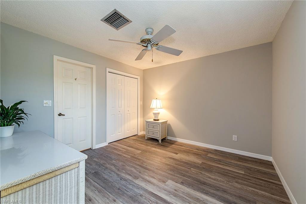 1672 Spoonbill Lane, Unit 1672 Naples, FL 34105 - Photo 10 of 12 a view of empty room with wooden floor and fan