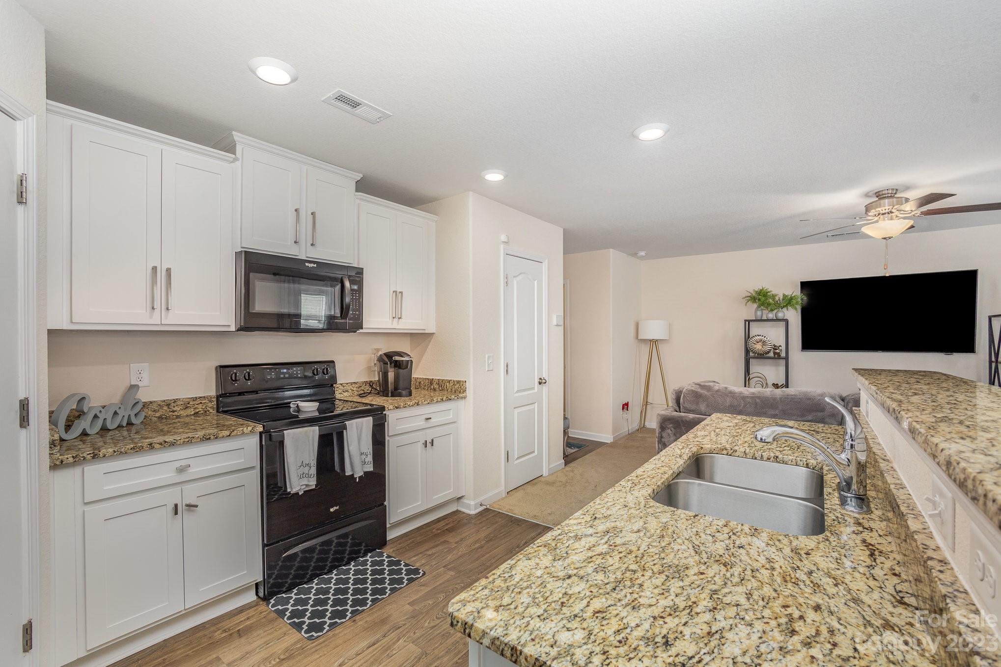 3201 Ellingford Road Charlotte, NC 28214 - Photo 11 of 29 a kitchen with stainless steel appliances granite countertop a sink stove and refrigerator