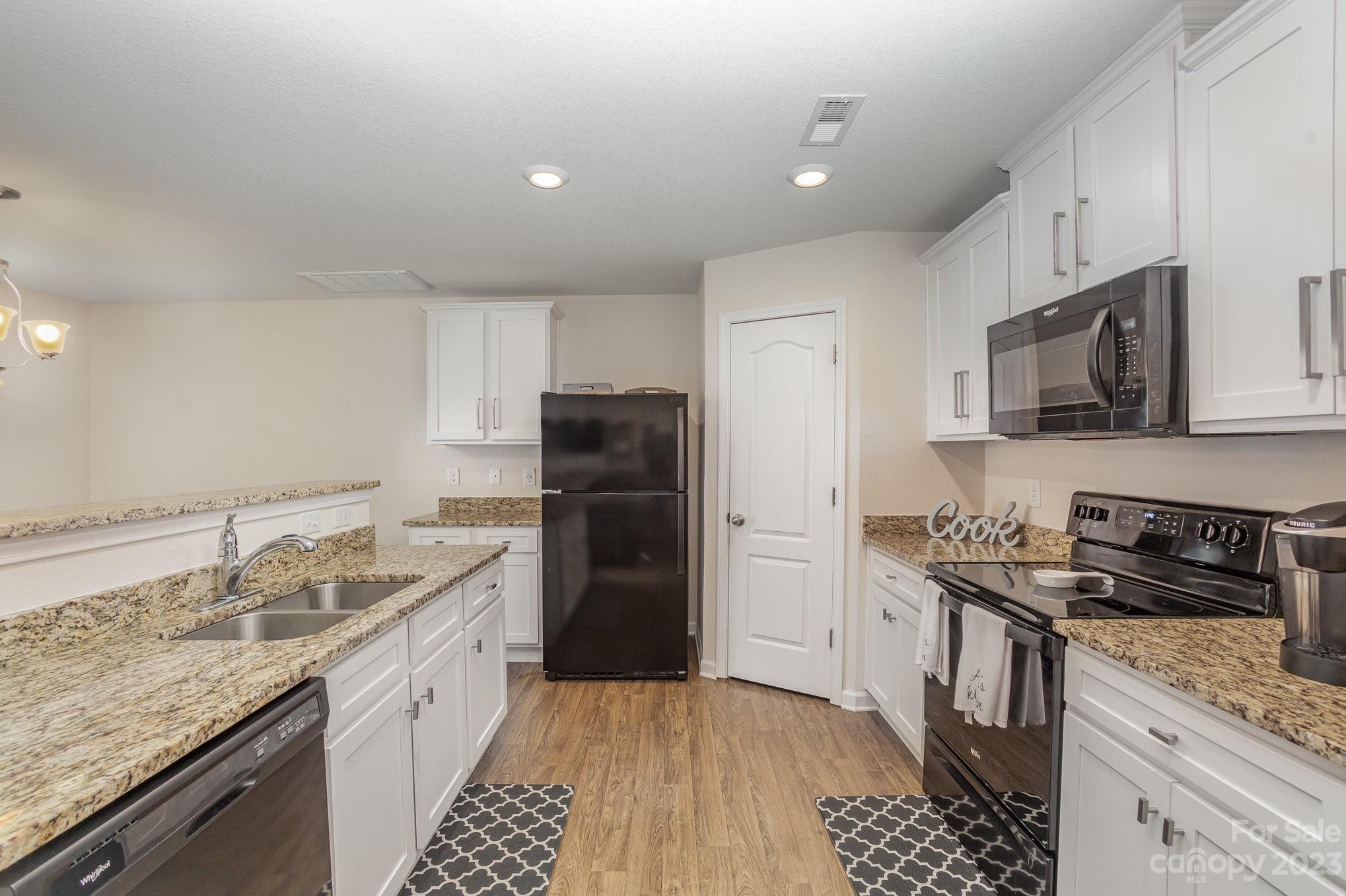 3201 Ellingford Road Charlotte, NC 28214 - Photo 13 of 29 a kitchen with granite countertop a sink stove and refrigerator