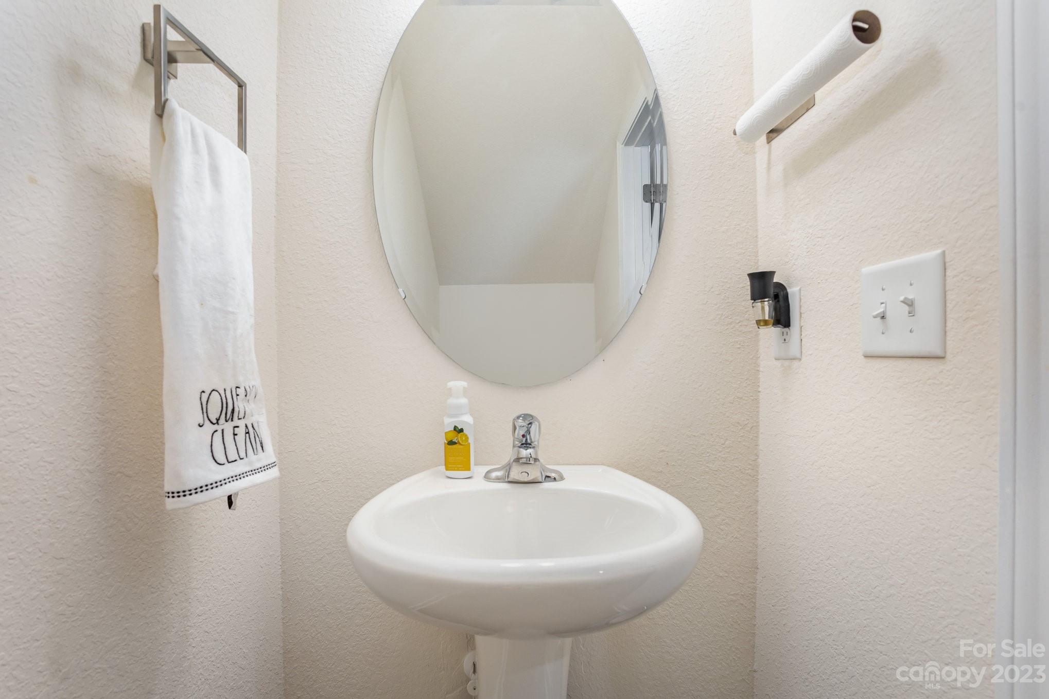 3201 Ellingford Road Charlotte, NC 28214 - Photo 15 of 29 a bathroom with a sink a mirror and vanity