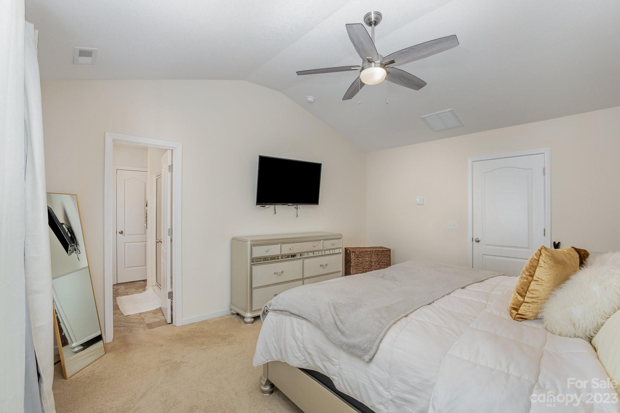 3201 Ellingford Road Charlotte, NC 28214 - Photo 20 of 29 a bedroom with a bed and a flat screen tv