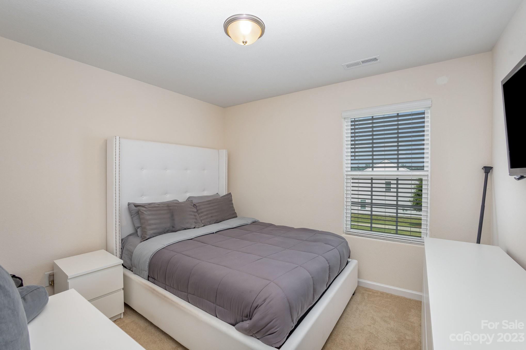 3201 Ellingford Road Charlotte, NC 28214 - Photo 24 of 29 a bedroom with a bed and a large window