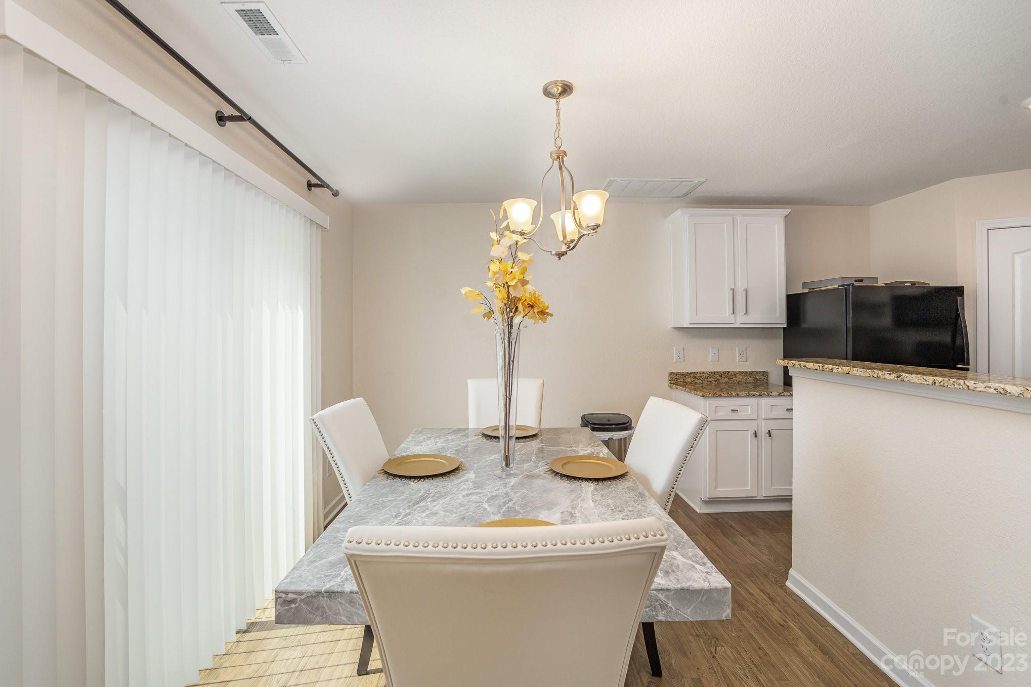 3201 Ellingford Road Charlotte, NC 28214 - Photo 8 of 29 a dining room with furniture and chandelier