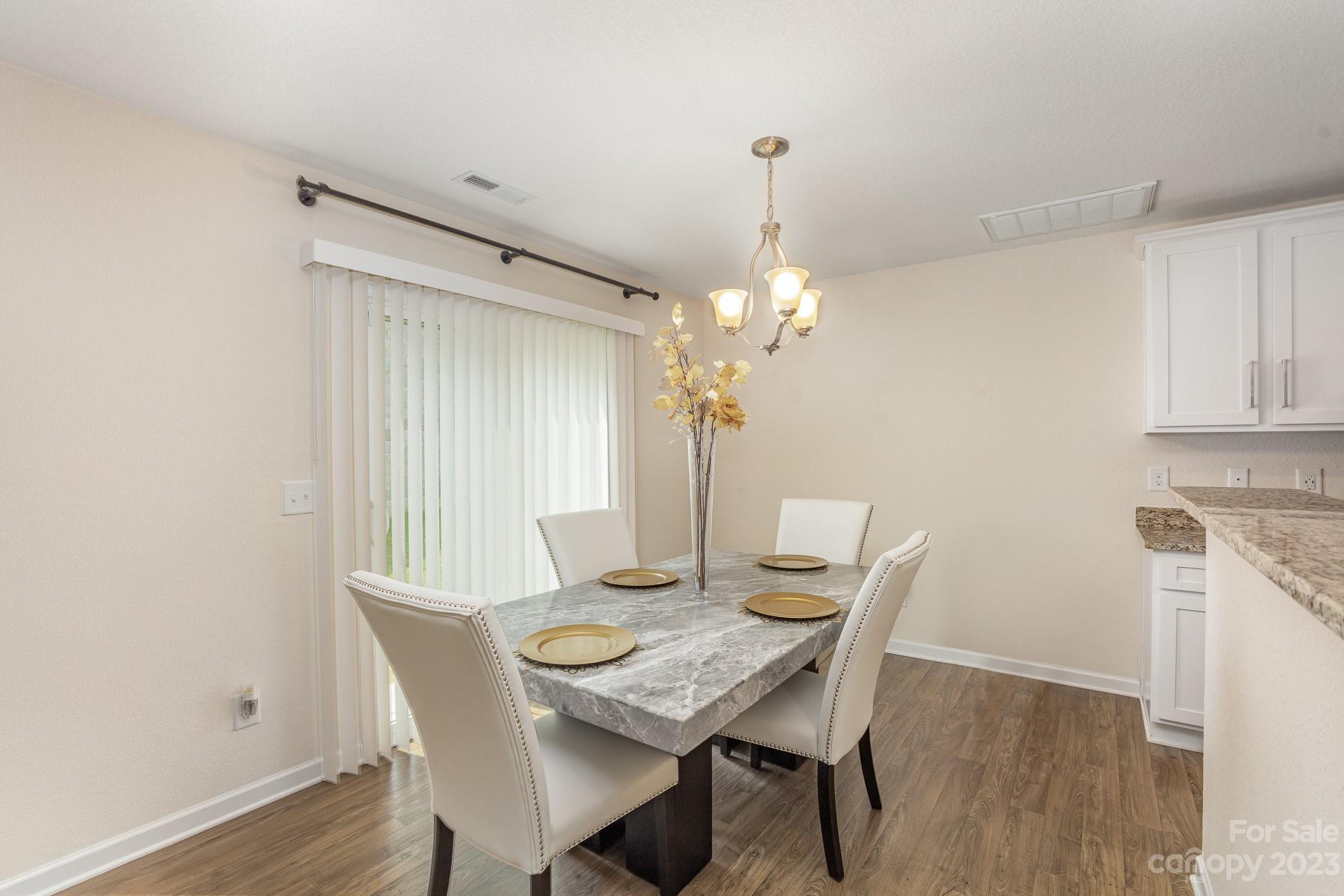 3201 Ellingford Road Charlotte, NC 28214 - Photo 9 of 29 a view of a dining room with furniture and wooden floor