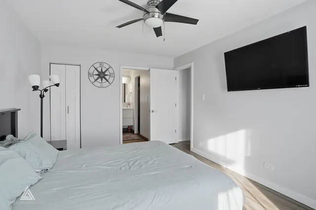 a bedroom with a bed and a flat screen tv