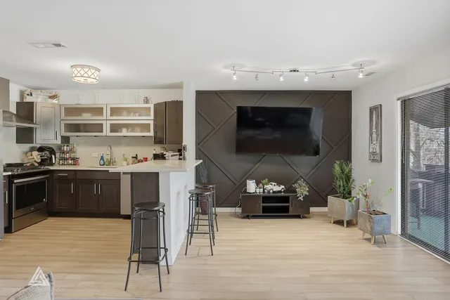 a kitchen with kitchen island granite countertop a stove and a sink