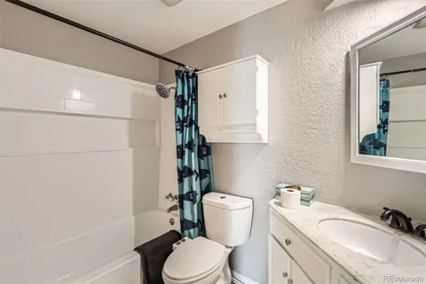 a bathroom with a sink toilet vanity and shower