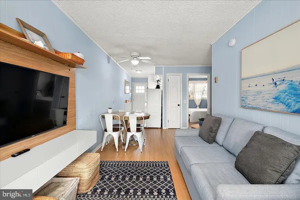 a living room with furniture a rug and a flat screen tv