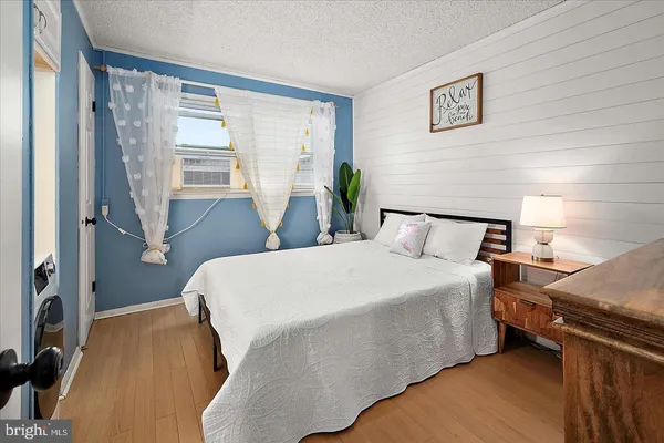 a bed sitting in a bedroom next to a window