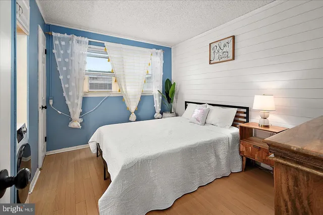 a bed sitting in a bedroom next to a window