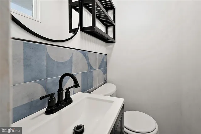 a bathroom with a toilet a sink and tub