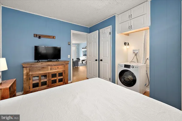 a bedroom with a bed and a flat screen tv