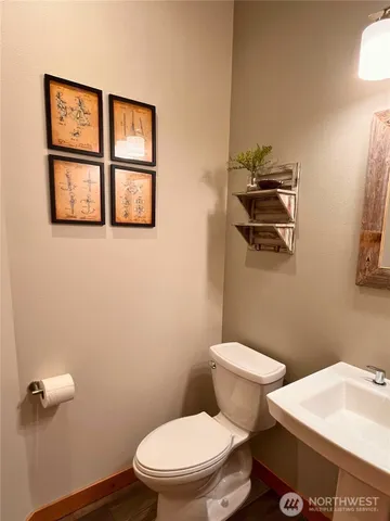 a white toilet sitting next to a bathroom sink