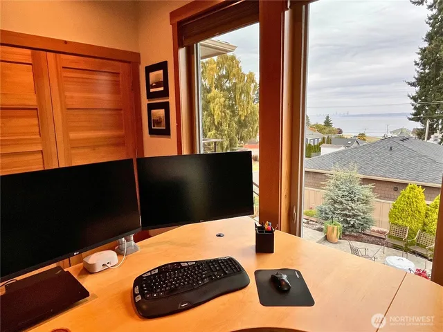 a bedroom with a bed and a flat tv screen