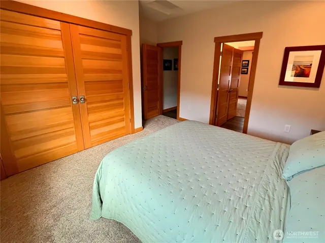 a bedroom with a bed and cabinets