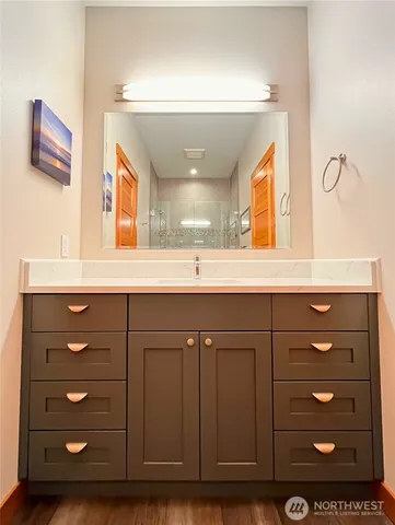 a bathroom with a sink vanity and mirror